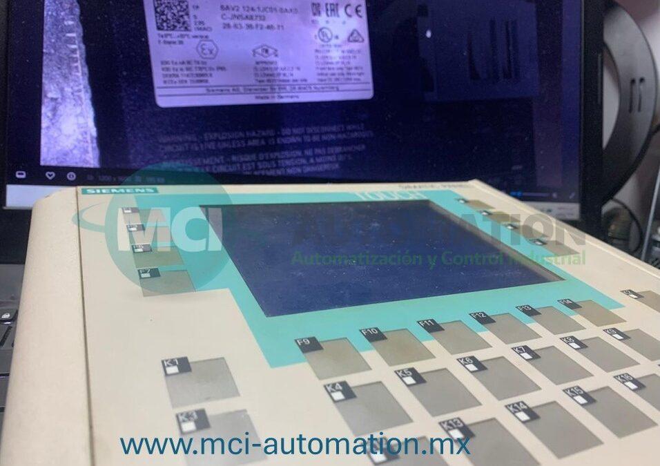 Ingeniero realizando diagnóstico de una pantalla HMI industrial conectada a un PLC durante labores de mantenimiento y solución de fallas en un sistema de automatización industrial.